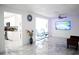 Bright living room with marble floors, white walls, and a modern ceiling fan at 6508 Lenore Dr, Tampa, FL 33634