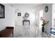 Open concept living room with marble floors, white walls, and modern furnishings at 6508 Lenore Dr, Tampa, FL 33634