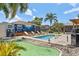Backyard paradise featuring a pool, putting green, cabana, and lounge chairs, perfect for recreation and relaxation at 6521 69Th N Ave, Pinellas Park, FL 33781