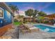 Beautiful backyard featuring a swimming pool, palm trees, mural, and seating at 6521 69Th N Ave, Pinellas Park, FL 33781