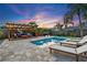 Relaxing backyard includes a pool, lounge chairs, covered pergola, and palm trees at 6521 69Th N Ave, Pinellas Park, FL 33781