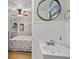 Bathroom sink leads into bedroom with ceiling fan, wood floors and natural light at 6521 69Th N Ave, Pinellas Park, FL 33781
