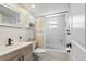 Tastefully updated bathroom with tub and shower features white tiling and shaker vanity at 6521 69Th N Ave, Pinellas Park, FL 33781