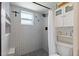 Modern bathroom features a walk-in shower with grey tiling, a black shower head, a built-in shelf, and pebble flooring at 6521 69Th N Ave, Pinellas Park, FL 33781
