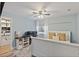 Bright bedroom features a workstation, overhead fan, walk-in closet, and a large bright window at 6521 69Th N Ave, Pinellas Park, FL 33781