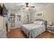 Bright bedroom boasts a ceiling fan, charming decor, wood floors and ample natural light at 6521 69Th N Ave, Pinellas Park, FL 33781