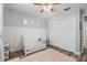 Light and airy Bedroom features a crib, closet, and classic wainscotting details at 6521 69Th N Ave, Pinellas Park, FL 33781