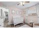 Cozy Bedroom with a white crib, soft rug, and ample natural light, perfect for a peaceful baby's room at 6521 69Th N Ave, Pinellas Park, FL 33781