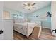 Stylish bedroom with a ceiling fan, ensuite bathroom, and a beautiful view from the bright double window at 6521 69Th N Ave, Pinellas Park, FL 33781