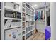 Organized walk-in closet with custom shelving, storage bins, and clothing racks at 6521 69Th N Ave, Pinellas Park, FL 33781