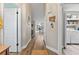 Inviting hallway with wood floors, leading to an open-concept kitchen and laundry area at 6521 69Th N Ave, Pinellas Park, FL 33781