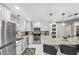 Bright kitchen features granite counters, stainless appliances, white cabinetry, and a large center island with bar seating at 6521 69Th N Ave, Pinellas Park, FL 33781