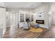 Cozy sitting area with a fireplace, built-in shelving, and comfortable armchairs on wood floor at 6521 69Th N Ave, Pinellas Park, FL 33781