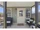 Cozy screened-in patio with comfortable seating, offering a serene outdoor living space with black framed windows and door at 6521 69Th N Ave, Pinellas Park, FL 33781