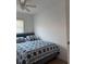 Bedroom with blue and white bed, and a sunny window at 6527 S West Shore Cir, Tampa, FL 33616
