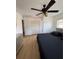 Spacious bedroom featuring hard wood flooring, a ceiling fan, and a large closet at 6527 S West Shore Cir, Tampa, FL 33616