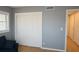 A blue couch sits next to a window and closet in this grey bedroom at 6527 S West Shore Cir, Tampa, FL 33616