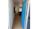 Inviting entryway with a bright blue door, light wood floors, and decorative wall paneling at 6527 S West Shore Cir, Tampa, FL 33616