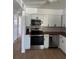 Modern kitchen featuring stainless steel appliances and white cabinets at 6527 S West Shore Cir, Tampa, FL 33616