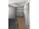 Functional laundry room with shelving and modern washer at 6527 S West Shore Cir, Tampa, FL 33616