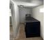 Compact laundry room features a modern black washer and dryer set with a water heater at 6527 S West Shore Cir, Tampa, FL 33616
