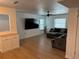 Spacious living room featuring light wood floors, a ceiling fan, and a comfortable gray sectional sofa at 6527 S West Shore Cir, Tampa, FL 33616