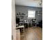 Office with desk and shelving, illuminated by a sunny window and ceiling fan at 6527 S West Shore Cir, Tampa, FL 33616