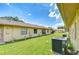 Lush backyard with a grassy lawn and mature landscaping at 6550 Teak Ct, Zephyrhills, FL 33542