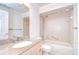 Bright bathroom features granite counters, shower-tub combo, and neutral tile at 6550 Teak Ct, Zephyrhills, FL 33542