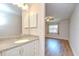 Bathroom features a vanity, countertop, and a view into the bedroom at 6550 Teak Ct, Zephyrhills, FL 33542