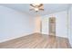 Bedroom with closet, light-colored walls, crown molding, and light-colored wood flooring at 6550 Teak Ct, Zephyrhills, FL 33542
