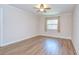 Bedroom featuring a window, ceiling fan, crown molding, and light-colored wood flooring at 6550 Teak Ct, Zephyrhills, FL 33542
