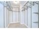 Walk-in closet featuring multiple rows of shelving with carpet flooring at 6550 Teak Ct, Zephyrhills, FL 33542