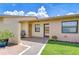 Inviting front entrance with a cozy seating area, decorative plants, and well-maintained landscaping at 6550 Teak Ct, Zephyrhills, FL 33542