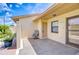 Inviting front entrance with a cozy seating area and decorative plants, creating a welcoming atmosphere at 6550 Teak Ct, Zephyrhills, FL 33542