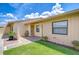 Charming front entrance with lush green lawn, decorative plants and seating area at 6550 Teak Ct, Zephyrhills, FL 33542