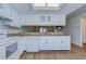 Updated kitchen with white cabinetry and modern appliances at 6550 Teak Ct, Zephyrhills, FL 33542
