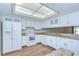 Updated kitchen featuring white cabinets and stainless steel appliances including range, dishwasher and refrigerator at 6550 Teak Ct, Zephyrhills, FL 33542