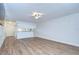 Spacious living room with breakfast bar, wood flooring, and ceiling fan at 6550 Teak Ct, Zephyrhills, FL 33542