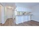 Open-concept living room with wood flooring, breakfast bar, and ceiling fan at 6550 Teak Ct, Zephyrhills, FL 33542