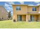 A view of the backyard featuring a well-maintained lawn and a sliding glass door to the patio at 6920 Towering Spruce Dr, Riverview, FL 33578