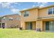 A view of the backyard featuring a well-maintained lawn and a covered patio area at 6920 Towering Spruce Dr, Riverview, FL 33578