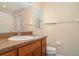 Well-lit bathroom features shower-tub combo and wood vanity with laminate counters at 6920 Towering Spruce Dr, Riverview, FL 33578