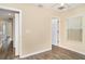 Bedroom features hard surface floors and view of the hallway at 6920 Towering Spruce Dr, Riverview, FL 33578