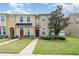 Well-maintained townhome exterior with vibrant landscaping, sidewalk, and manicured lawn at 6920 Towering Spruce Dr, Riverview, FL 33578