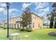 Townhome exterior with neat lawn, sidewalk and beautiful landscaping with a light pole at 6920 Towering Spruce Dr, Riverview, FL 33578