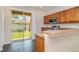 Modern kitchen with stainless steel appliances, lots of cabinets and view to back yard at 6920 Towering Spruce Dr, Riverview, FL 33578
