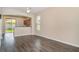 Open living space with wood-look flooring and views into the kitchen area and backyard at 6920 Towering Spruce Dr, Riverview, FL 33578