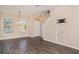 Bright living room with dark floors, an entry door and a stairway to the upper level at 6920 Towering Spruce Dr, Riverview, FL 33578