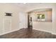 Open floorplan with living space, entry door, and kitchen in a modern home at 6920 Towering Spruce Dr, Riverview, FL 33578